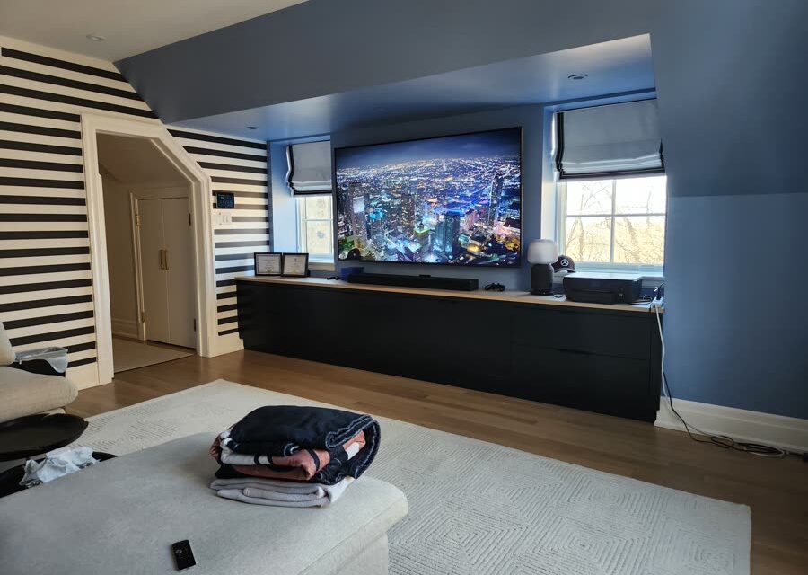 Media room with large-format display and concealed speakers