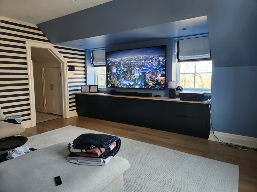 Media room with large-format display and concealed speakers