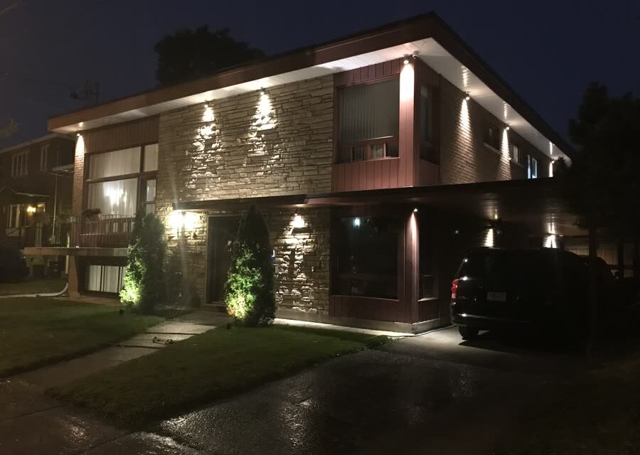 Modern residence at night with architectural landscape lighting