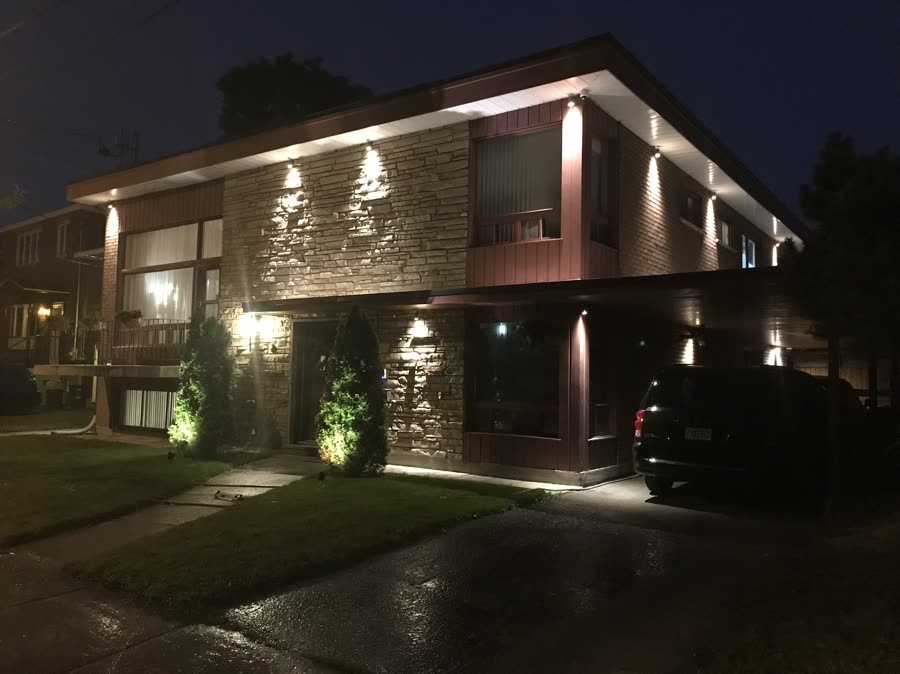 Modern residence at night with architectural landscape lighting
