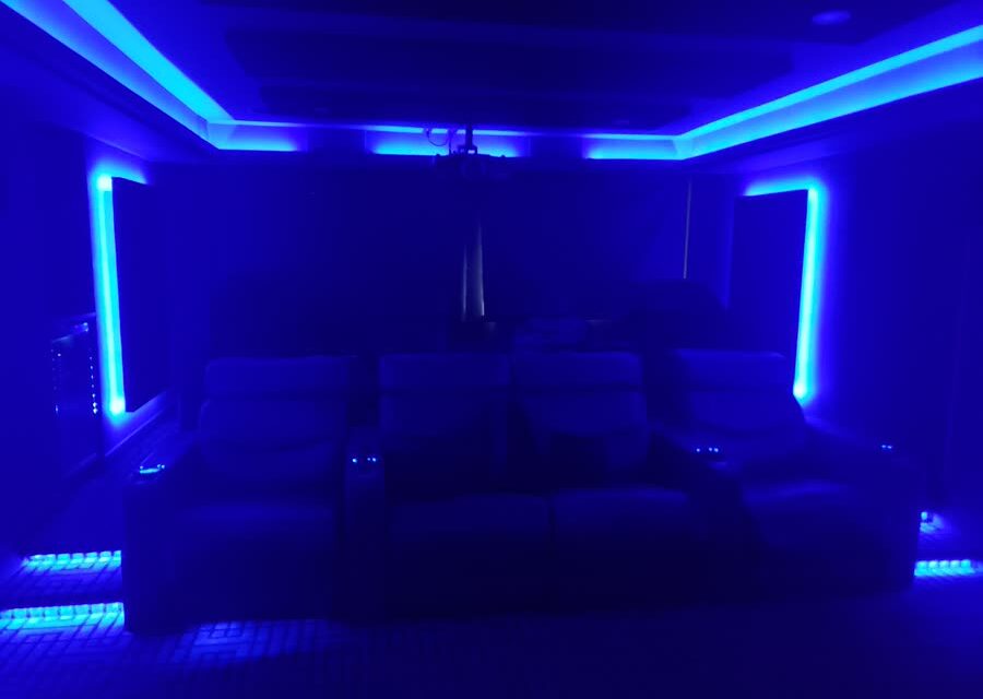 Private cinema with tiered seating and cove lighting