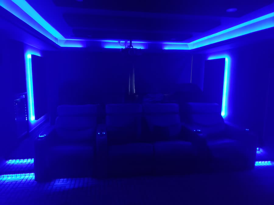 Private cinema with tiered seating and cove lighting
