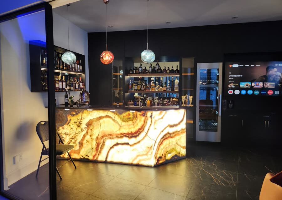 Commercial bar with backlit counter, displays and background audio