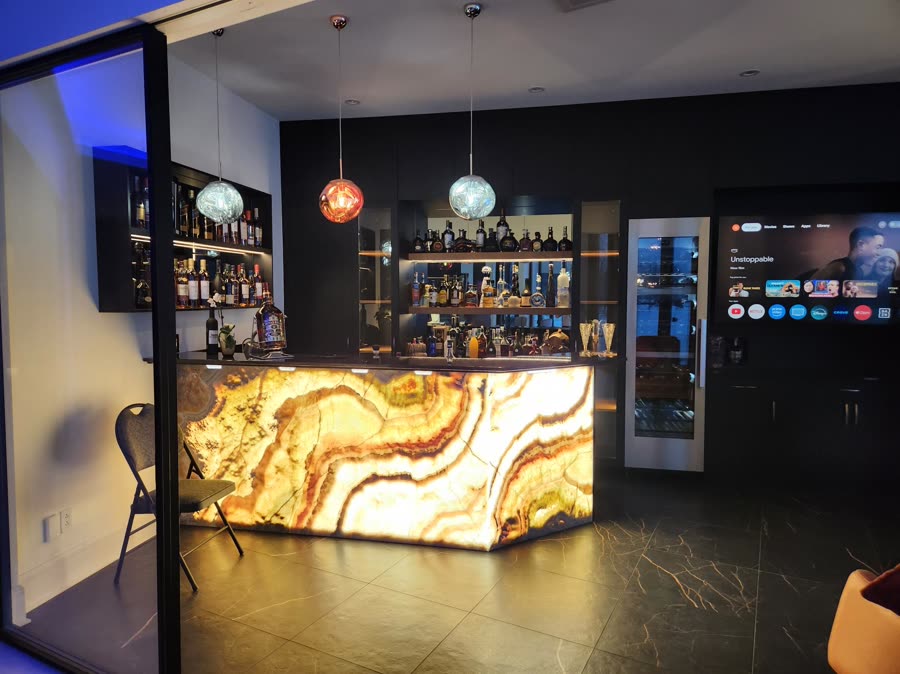 Commercial bar with backlit counter, displays and background audio