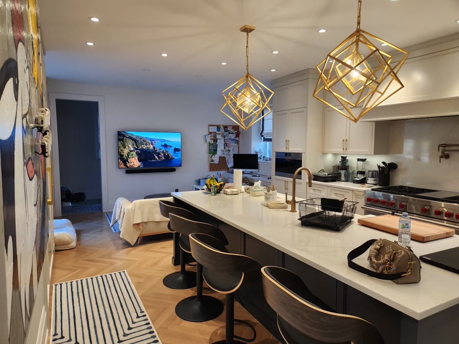 Open kitchen with pendant lighting and integrated display
